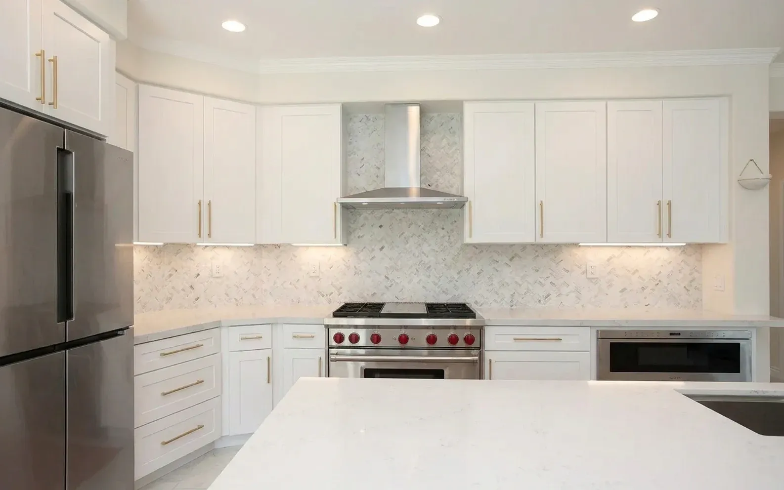 A kitchen with a professional range and a marble backsplash